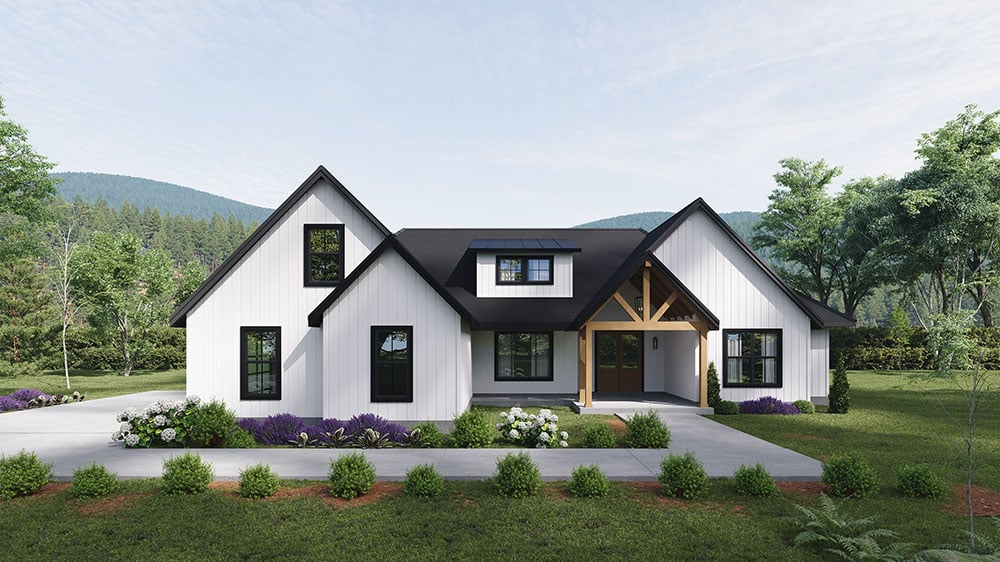 White Modern Farmhouse with black roof, timber-framed entry gable, and manicured garden set against a green hillside landscape.
